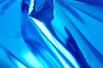 Bright blue holographic foil background. Trendy backdrop