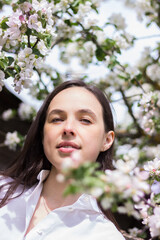 girl in the flowers of the apple tree