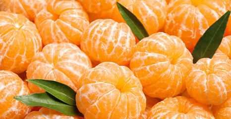 Peeled fresh ripe tangerines as background, closeup. Banner design