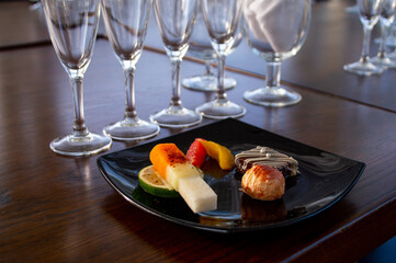 Plate with gourmet chocolates on wooden table