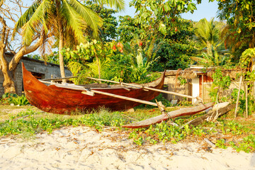 Traditional aboriginal Malagasy wooden hand made fisherman dugout catamaran boat the beach in Nosy Be, Indian ocean,  Madagascar