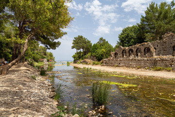 Ruins of the ancient city of Olympos in Cirali village in Antalya, Turkey.  Local and foreign tourists come to visit the ancient city and swim.