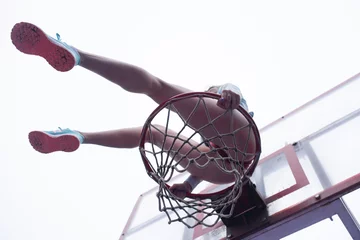 Deurstickers  Young girl sitting on a basketball hoop © Arthur