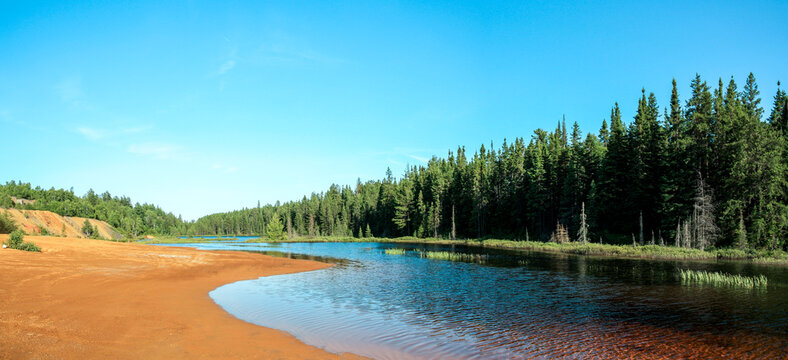 Idyllic Blue lake and forest landscape in evening sunset sunlight. Foy, Foyross Lake, Sudbury, Ontario, Canada.