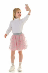 The girl is using a cell phone.The concept of people and technology.