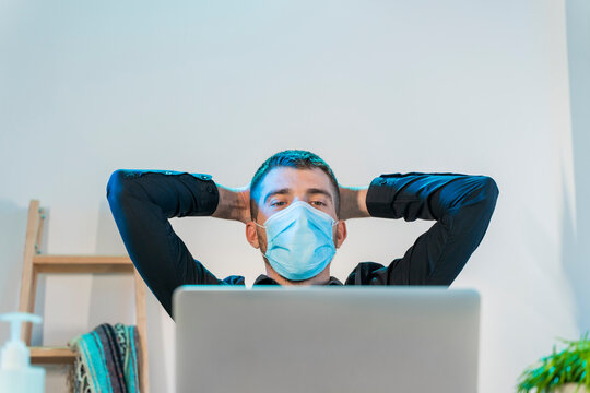 Business man working at home with computer. Small company working and doing business. Home working during quarantine concept. Little office. Coronavirus. Sanitizer gel and face mask.