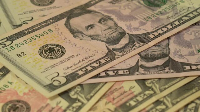 Closeup view 4k video footage of paper dollars money faling down on table. Person counting cash.