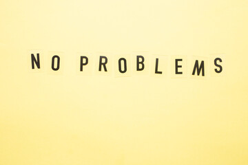 NO PROBLEMS inscription on a yellow background close-up.