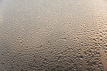 Abstract texture of blurry water drops on glass