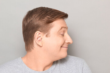 Obraz premium Portrait of funny happy man dreaming about something pleasant