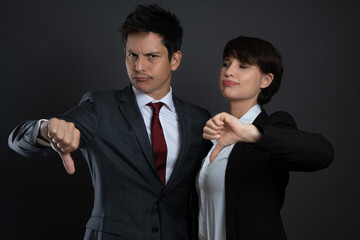 a man and a woman in suits isolated on gray background