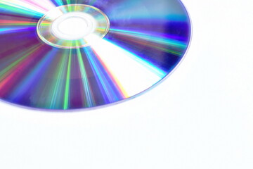 CD or DVD with colorful light reflection on surface in white background