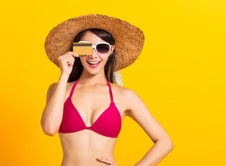 young beautiful woman wearing swimsuit bikini and showing credit card