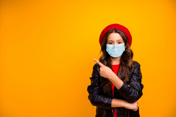 Portrait of attractive confident long-haired girl wearing safety gauze mask demonstrating tips news novelty mers cov infection copy space isolated bright vivid shine vibrant yellow color background