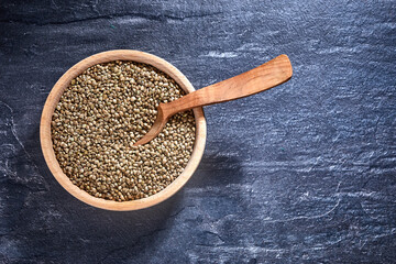 hemp seeds and a wooden spoon on a dark table. Healthy food concept.