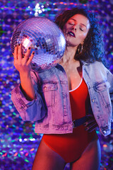 Young beautiful girl with long curly hair in ultraviolet light.