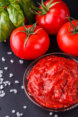 fresh natural tomato paste on black background
