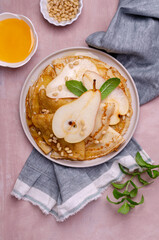 Crepes with pears, nuts and honey
