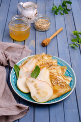 Crepes with pears, nuts and honey