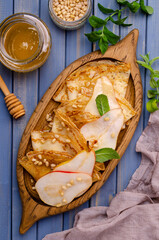 Crepes with pears, nuts and honey