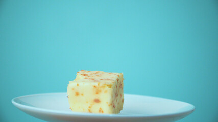 the cut cake rotates on a white plate