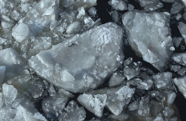 Broken ice floats on the river