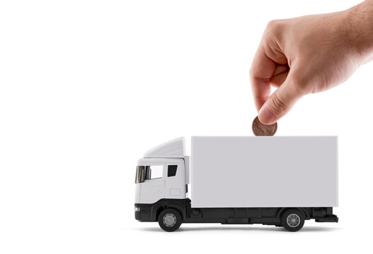 Putting coin into the white cargo delivery truck on white background