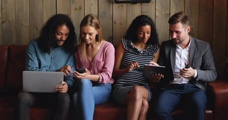 Happy diverse young people using apps on phones laptop tablet talking share social media online news sit together, multiracial friends hold devices gadgets having fun, people and technology concept - Powered by Adobe