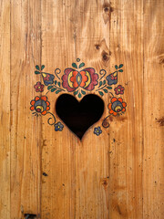 traditional heart-shaped opening on the door to a dry toilet, closeup
