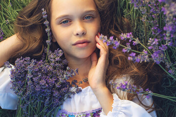 A child in lavender. Beautiful girl in a field with lavender.