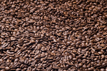 Roasted coffee beans background - full frame detail. Close up of a brown surface texture of aroma black caffeine drink ingredient for coffee beverage