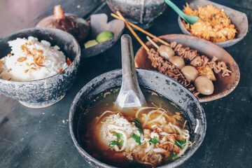 Soto Batok. Javanese beef clear soup with bean sprouts and rice; served in a traditional bowl made of coconut shell, locally known as ‘batok’. Accompanied with side dishes and condiments.