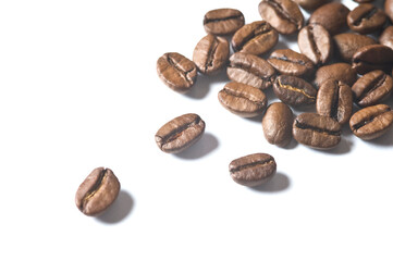 Roasted coffee beans isolated on white background - detail. Close up of a brown bean of aroma black caffeine drink ingredient for coffee beverage.