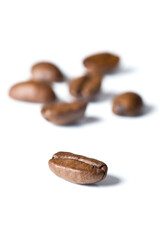 Roasted coffee beans isolated on white background - detail. Close up of a brown bean of aroma black caffeine drink ingredient for coffee beverage.