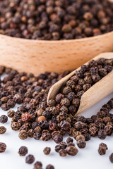 fragrant black pepper on white acrylic background