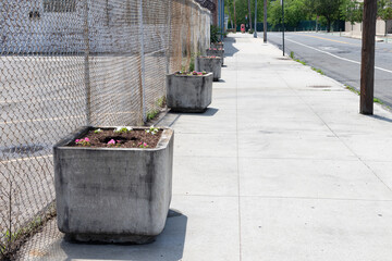 Empty Sidewalk with a Row of Stone Flower Planters in Long Island City Queens New York