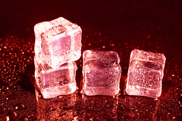 ice cubes on a reflections red light.