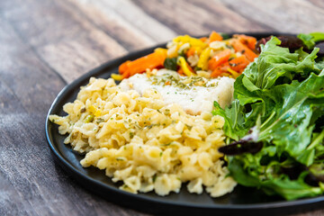 cod fish with vegetables, small vegetables and marine sauce