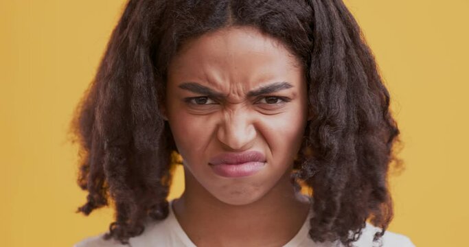 Disgusted black woman feeling aversion, frowning face