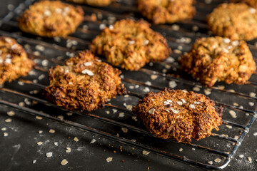 Homemade baked oatmeal cookies with dark background