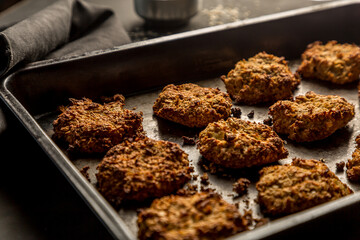 Homemade baked oatmeal cookies with dark background