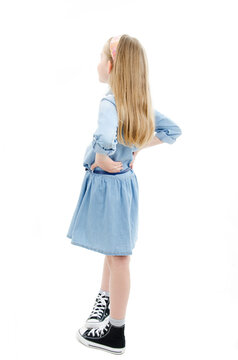 Adorable little girl looking at wall. Back view. Isolated on white background 
