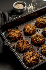 Homemade baked oatmeal cookies with dark background