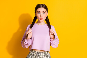 Portrait of sweet lovely teenager girl hold her strong silky tails she prepare for dating send air kiss wear good look clothes isolated over bright color background