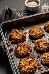Homemade baked oatmeal cookies with dark background