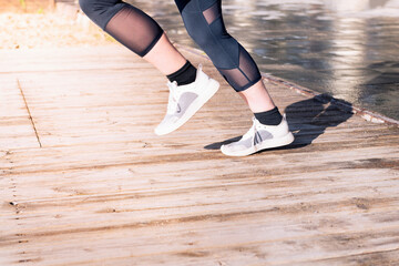 Fototapeta na wymiar female runner legs jogging in running shoes