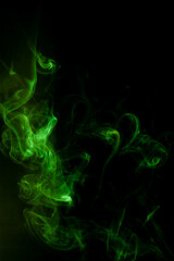 Green smoke motion on black background.