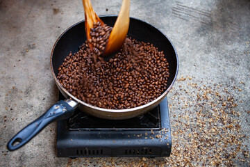 Traditional roasting coffee at home,  freshly roasted coffee beans.