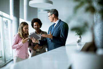 Group of business people using digital tablet at meeting in the office