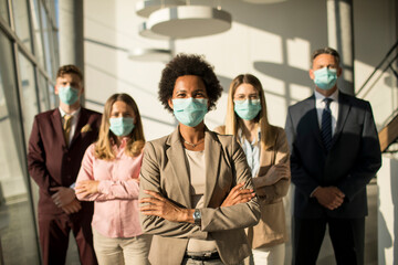 Group of asian business people standing in office and wear mask for protect prevent infection by...
